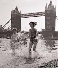 Children paddling on the foreshore below Tower Bridge