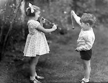 Young girl and boy playing conkers