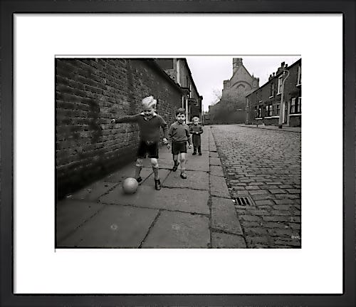 Children playing football by Mirrorpix